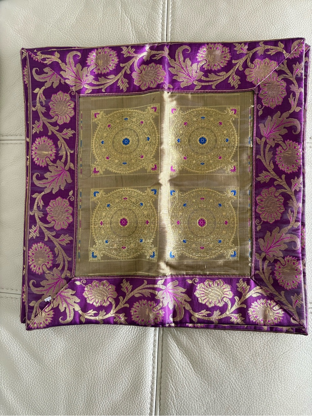 Beautiful purple and gold decorative cushion cover with an elegant floral design